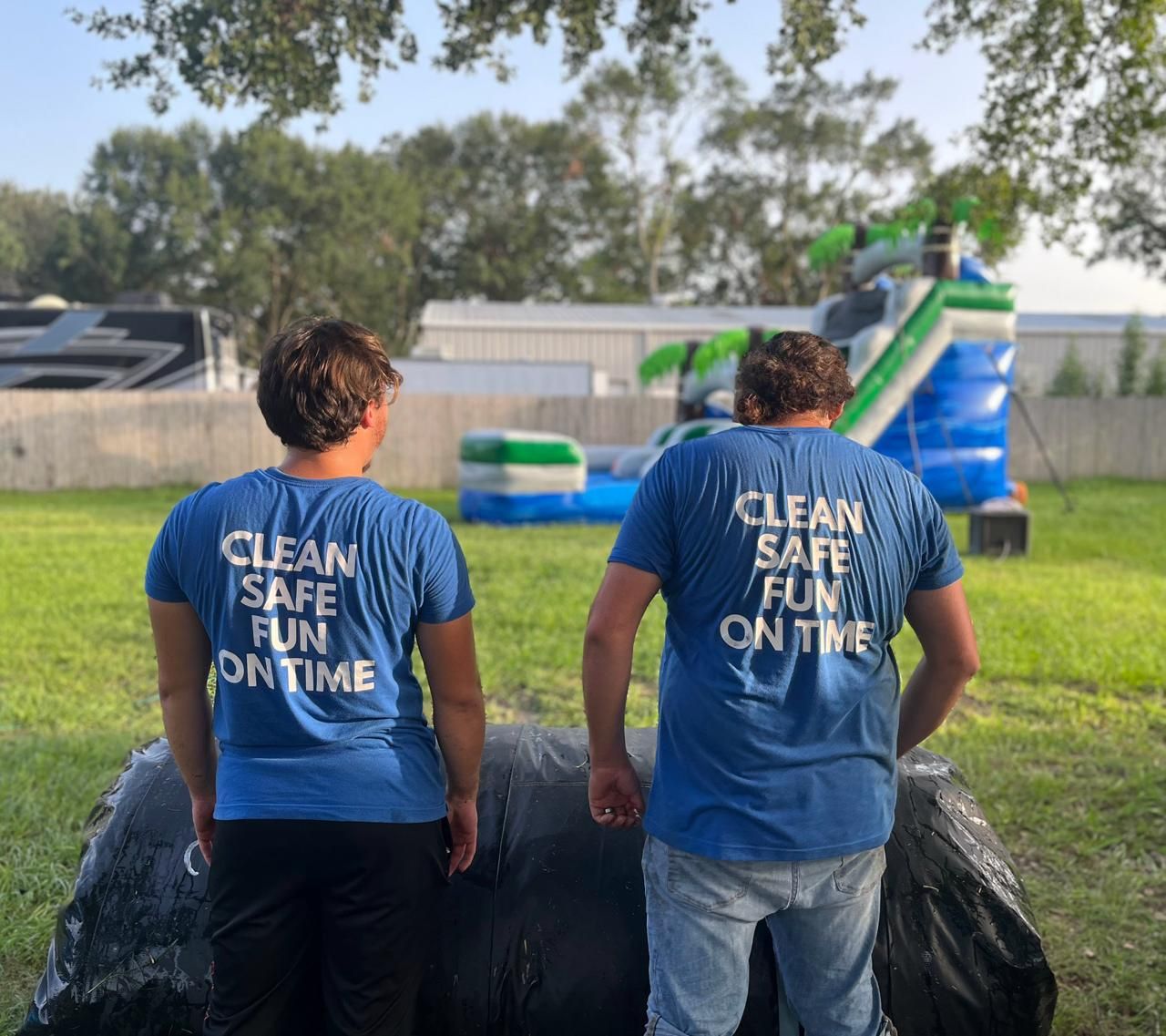 Sky High Party Rentals crew wearing Clean, Safe, Fun, On Time shirts at a setup
