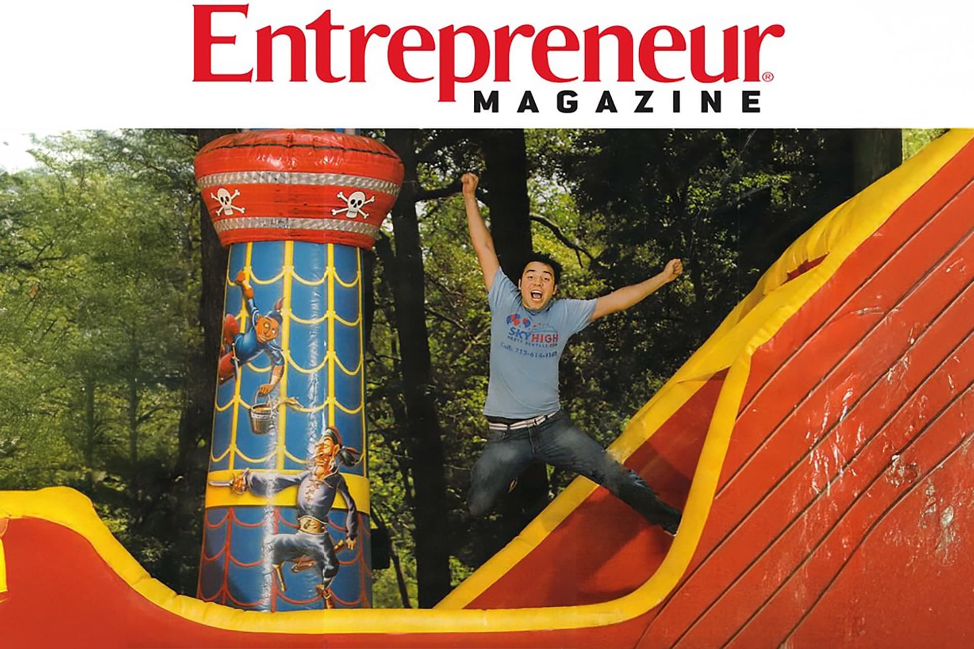 Founder Robert De Los Santos jumping beside an inflatable, from his Entrepreneur Magazine feature